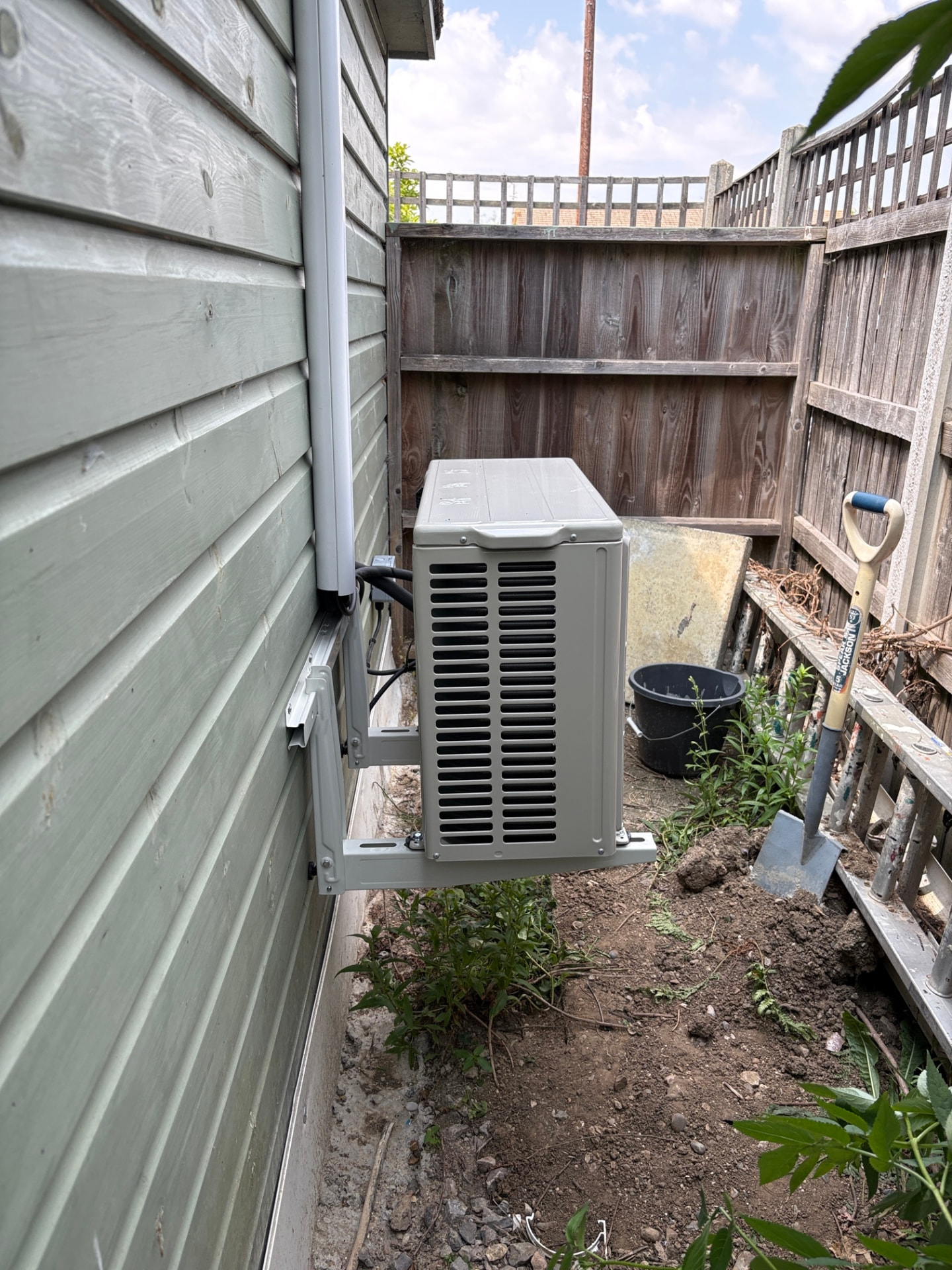 Outdoor air conditioning unit and pipework installed by Georgio's engineers