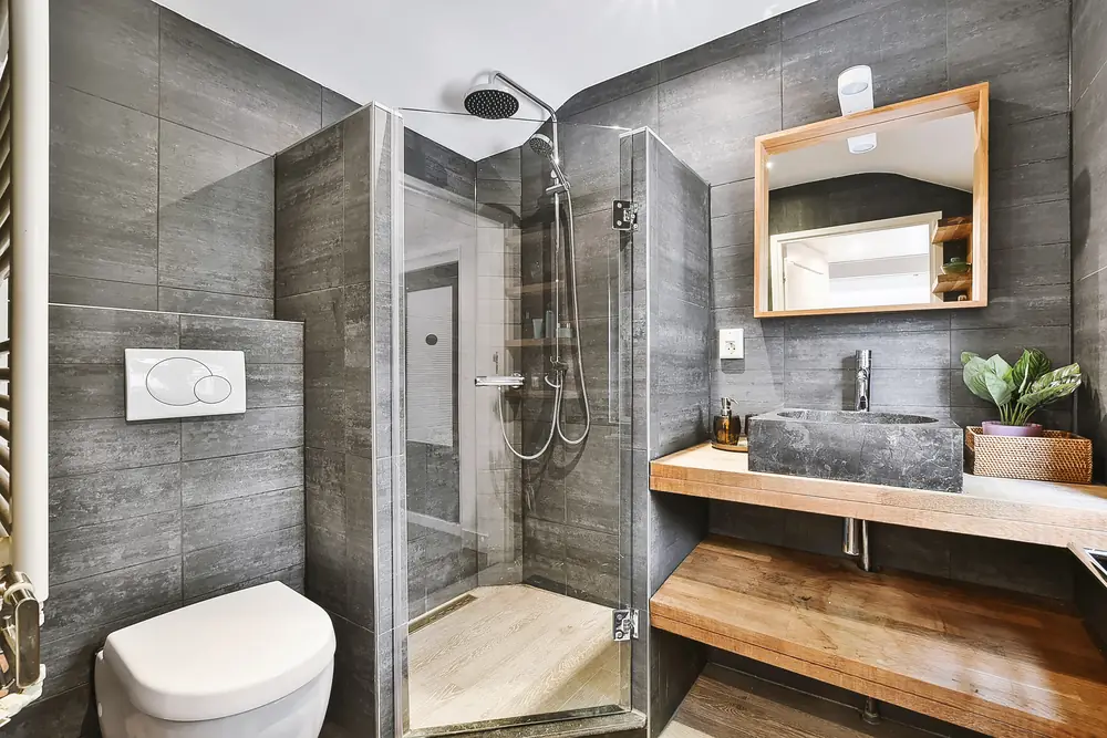 Modern bathroom with newly installed, toilet, shower and various bathroom accessories