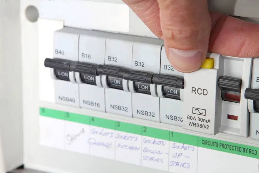 Electrician checking over electrical unit in home