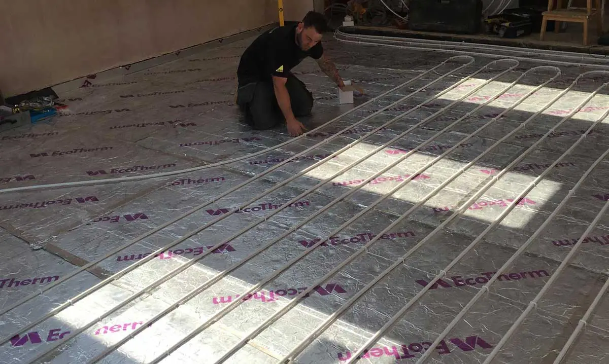 Georgio's employee working on underfloor heating at a home