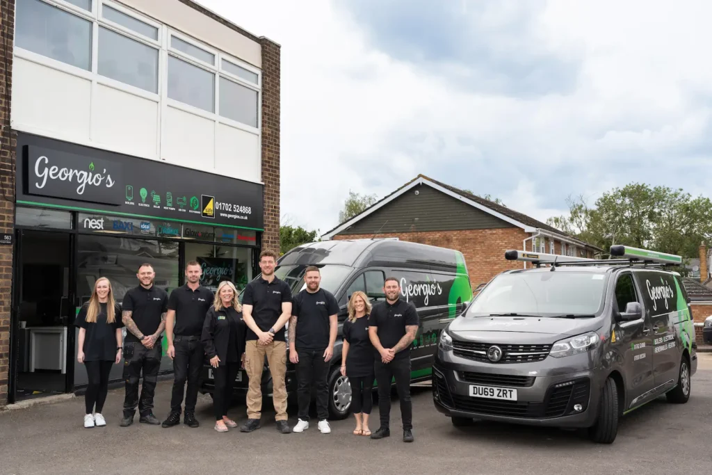 Picture of the Georgio's team standing outside their office with the fleet