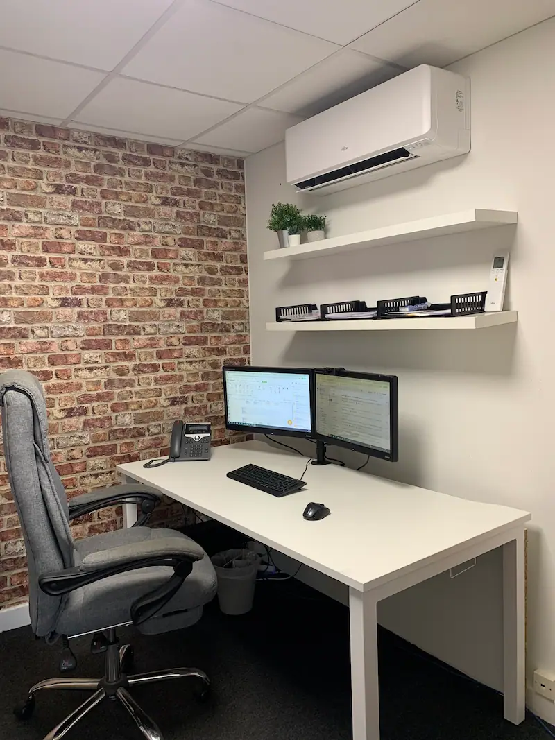 Air conditioning unit installed on a wall in an office room